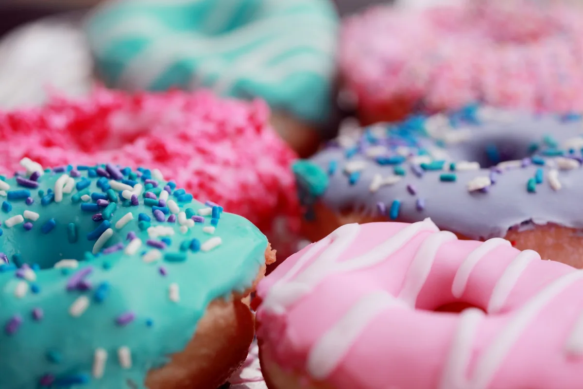 Close-up of colorful iced donuts topped with sprinkles